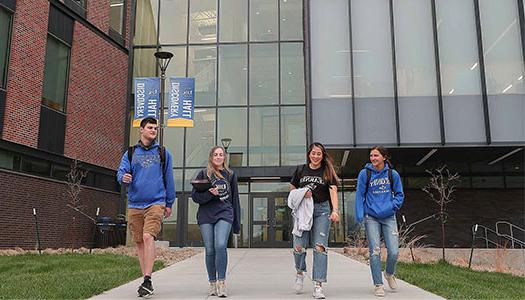 students walk together outside discovery hall